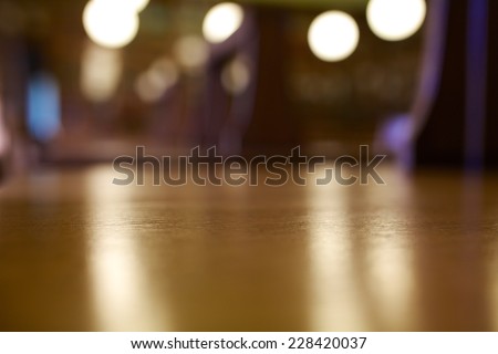 Long wooden desks at a old library with a blur background.