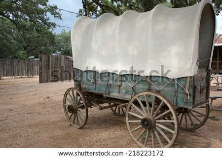 Covered wagon with green wood siding and white top