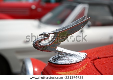 COLUMBUS, OHIO - CIRCA JULY 2010: Vintage red car with classic bird hood ornament.