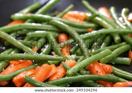 Green beans and carrots cooking in skillet