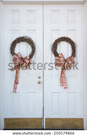Christmas wreaths hanging on doors outside