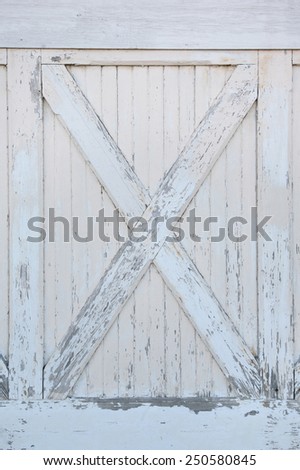 Close up of weathered warehouse doors with white peeled paint