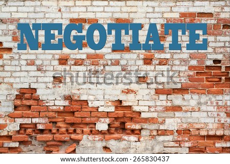 Negotiate Concept - Negotiate message in blue on decaying brick wall