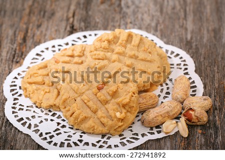Fresh Peanut Butter Cookies on white doily ready to eat and individual peanuts