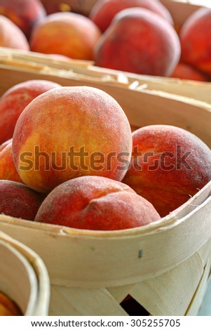 colorful ripe peaches in produce baskets at farmers market