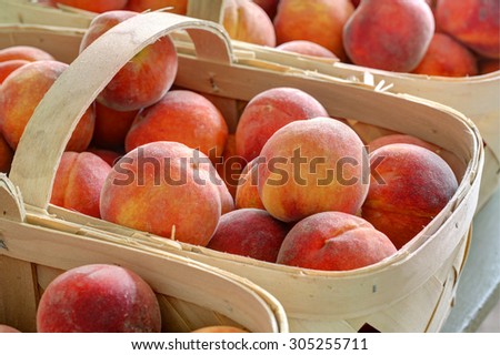 colorful ripe peaches in produce baskets at farmers market