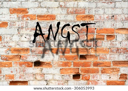 Angst - A road sign in german language, translation: fearful on decaying brick wall outdoors