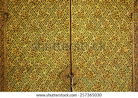 Ornamental pattern on Thai cabinet, close up detail of golden traditional Thai pattern detail