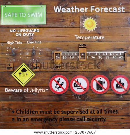 Beach safety signage written on the rustic timber plank board