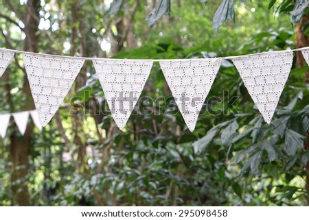 White color vintage style fabric triangle decortation party flag hanging with nature background
