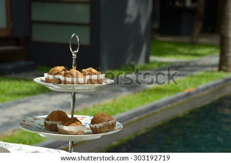 Banana cupcakes in the layer cake holder with nature background