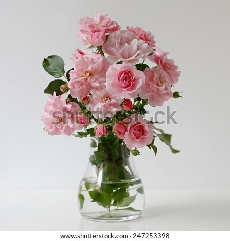 Bouquet of pink roses in a vase. Romantic floral still life with roses.