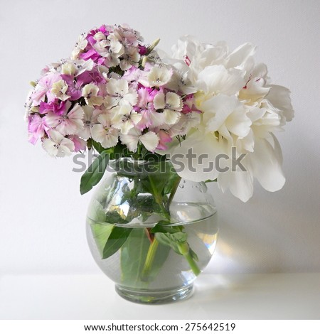 Still life with bouquet of peonies and sweet william flowers in a vase.