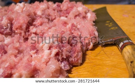 minced meat and a knife on a board