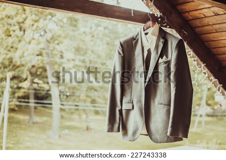 Grey jacket on wooden background Grey jacket on wooden background