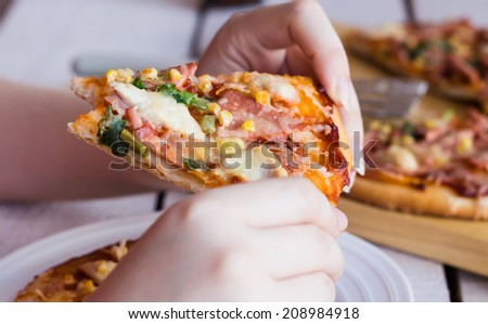 eating a slice of pizza hands