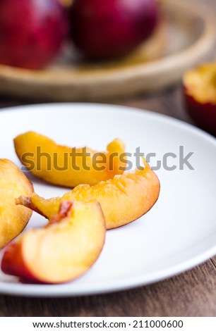 bright peach with a piece of wood on a wooden background
