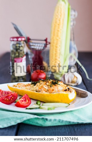 stuffed zucchini with chicken and vegetables, corn on the cob, vertically