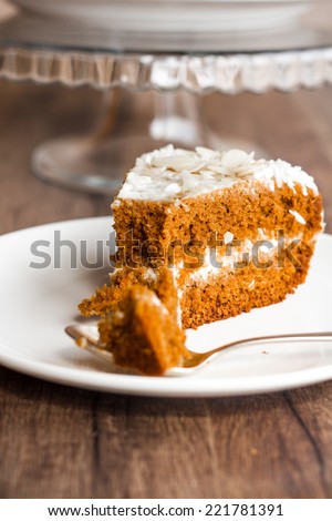 eat a piece of honey sponge cake with cream on a wooden board
