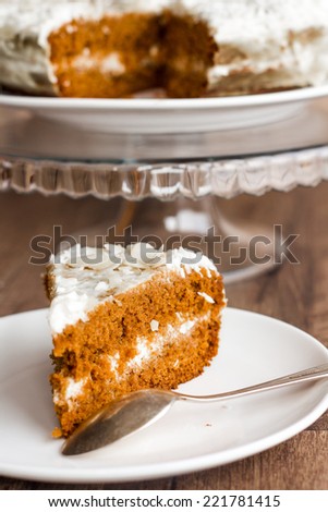 section of honey cake with whipped cream on a wooden board