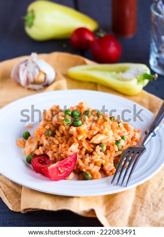 risotto with chicken and vegetables on a plate with fork,italy food