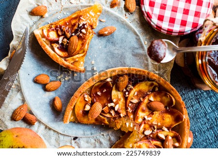 apple tart with caramel, a piece of cake, top view on a wooden board