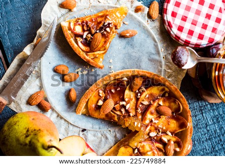 apple tart with caramel, a piece of cake, top view on a wooden board