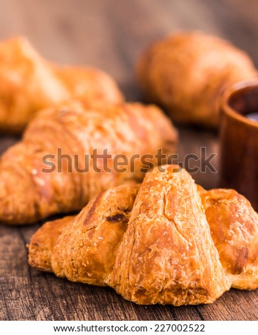 croissant with chocolate on a wooden board, coffee cup,french kitchen