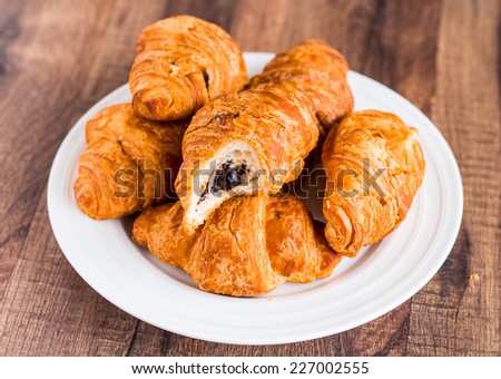 bite croissants with chocolate on a white plate, french kitchen