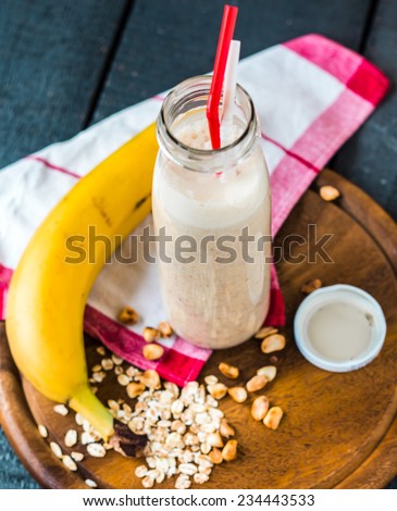 banana smoothie with oat flakes and milk in the bottle, breakfast,top view