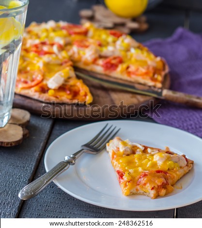 slice of pizza with chicken, corn, tomatoes and double cheese on a plate,Italian cuisine