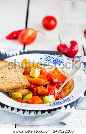 steamed vegetables on the plate with bread, vegan food