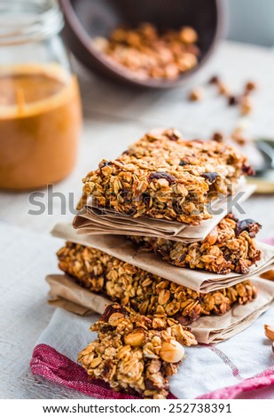 protein bars granola with seeds, peanut butter and dried fruit, healthy snack on wooden background