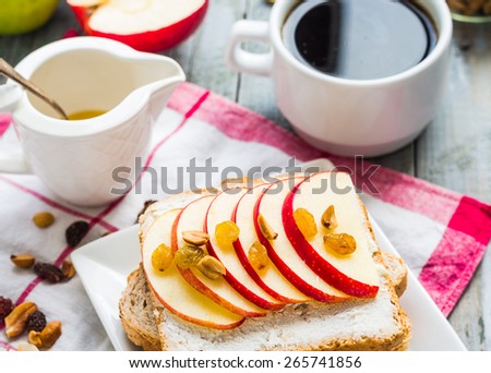 Toast with cheese, apple and dried fruit, a cup of coffee, healthy breakfast on a gray board