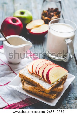 toast with curd cheese and sweet red apple, a cup of milk, healthy food