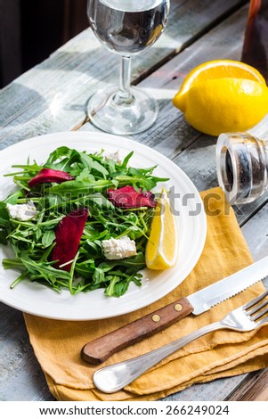 green salad with arugula beet and goat cheese, lemon, organic food,clean eating