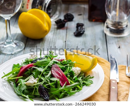 light green salad of arugula with beets, goat cheese and prunes, diet