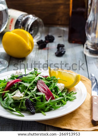 light green salad of arugula with beets, goat cheese and prunes, diet