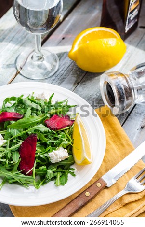 green salad with arugula beet and goat cheese, lemon, organic food,clean eating