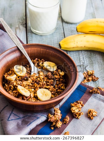 homemade granola with bananas, nuts and dates, milk, healthy food