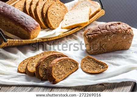 assortment of baked bread, slices of rye bread, bran cereal, rustic