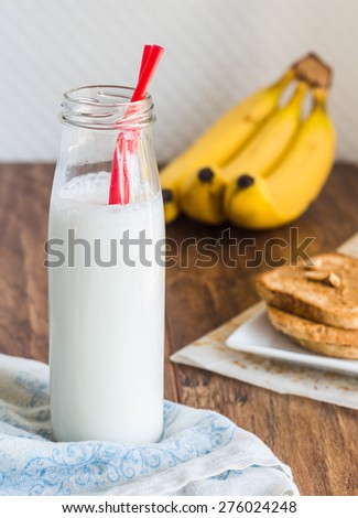 banana smoothie, toast with peanut butter, roasted peanuts, breakfast on a light background