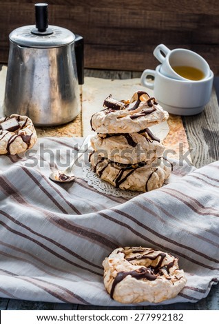 meringue cake with chocolate, caramel and nuts, dessert, rustic, french cuisine, selective focus