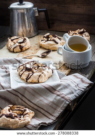 meringue cake with chocolate, caramel and nuts, dessert, rustic, french cuisine, selective focus