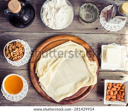 Ingredients for making homemade baklava,phyllo dough, nuts, honey, butter, top view, traditional Turkish dessert, tinted