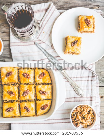 pieces of baklava with honey and nuts on a plate, top view, rustic, traditional Turkish dessert