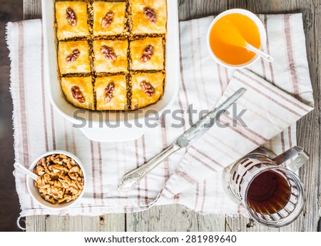 pieces of baklava with honey and nuts on a plate, top view, rustic, traditional Turkish dessert