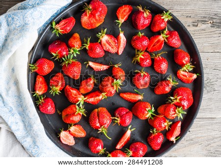fresh juicy strawberries on a black tray, top view, clean eating