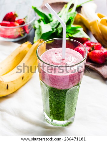 double smoothies, green with spinach, kiwi and banana with strawberries, bright drink, healthy food, selective focus