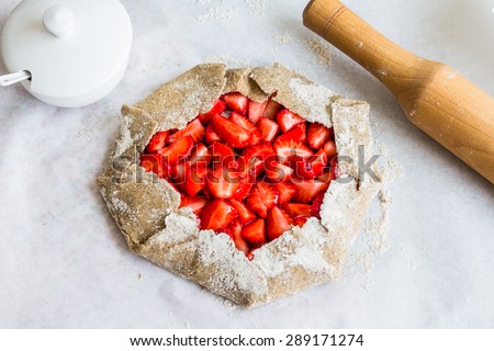 cooking processes biscuit with fresh strawberries, healthy dessert, raw pie, vegan